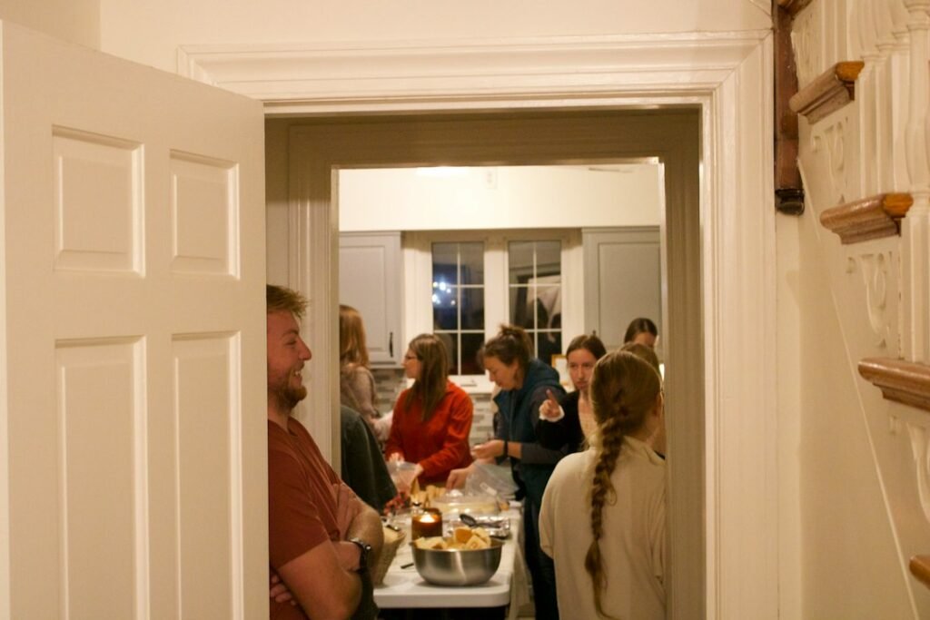 Large group gathered in a kitchen for a Christmas party