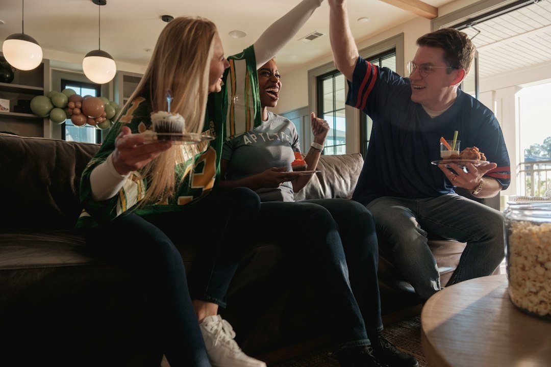 Group of adult friends laughing together at a home party