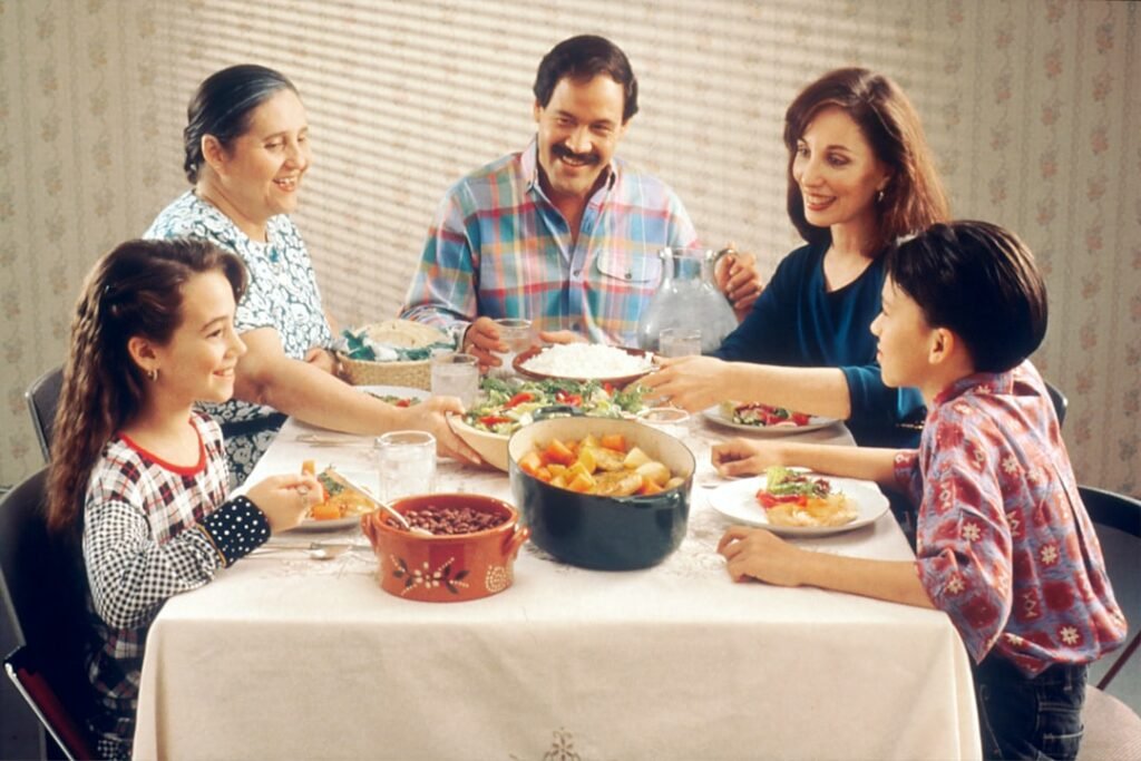 Family sharing a Thanksgiving meal together around a table